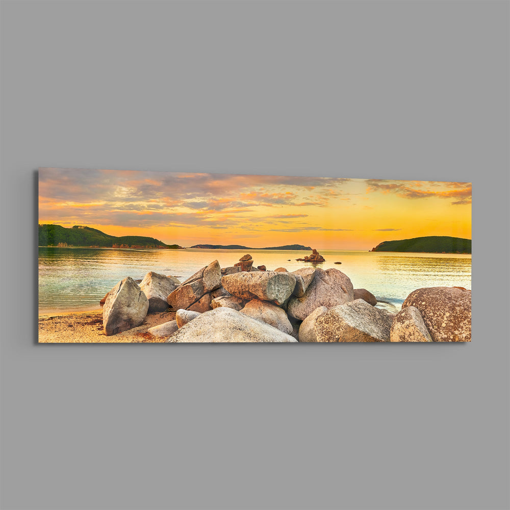 Boulder Pile Golden Sunset Bay Glass Wall Art lifestyle preview E
