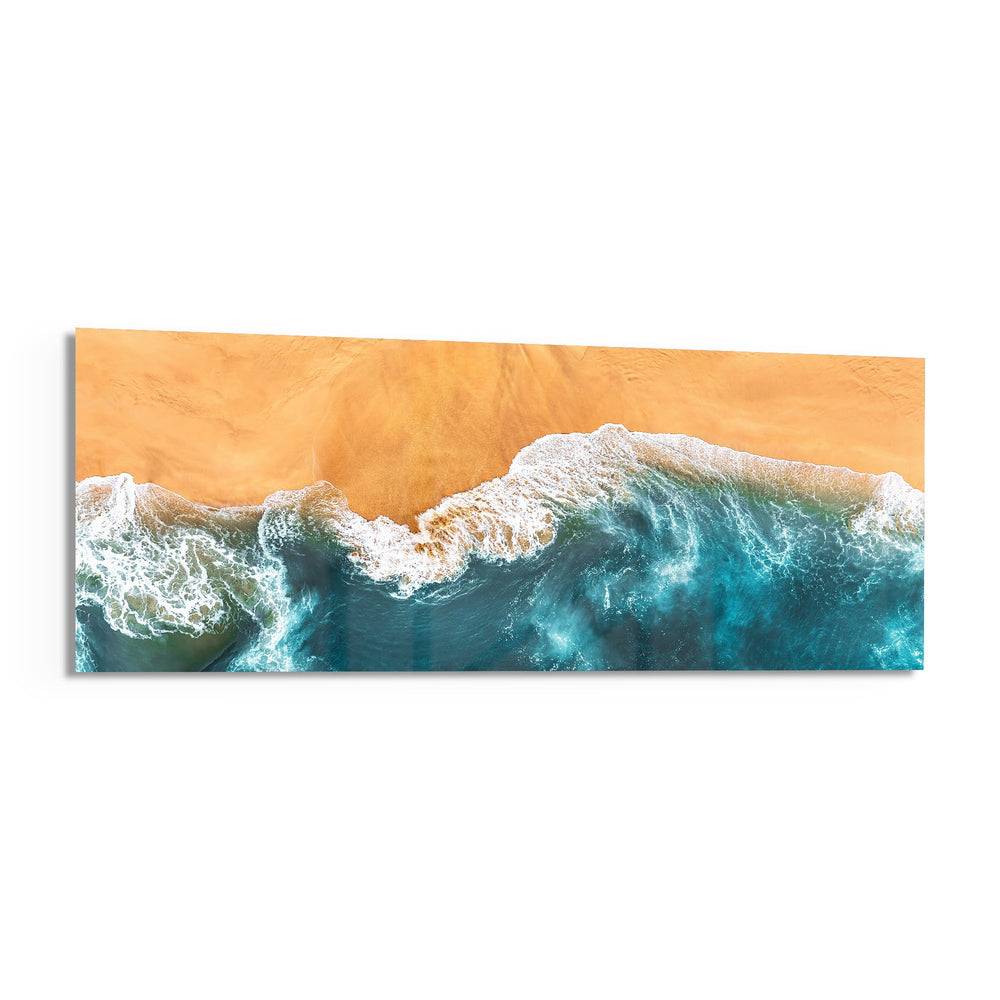 A top-down aerial view of turquoise waves rolling in white foam onto golden sand. panoramic glass wall art F