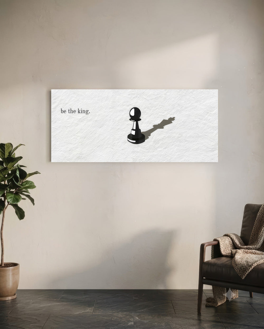A single black chess pawn casting the long shadow of a king across a white textured surface, with a short motivational line of text panoramic glass wall art C