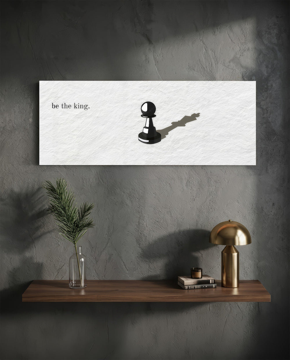 A single black chess pawn casting the long shadow of a king across a white textured surface, with a short motivational line of text panoramic glass wall art D