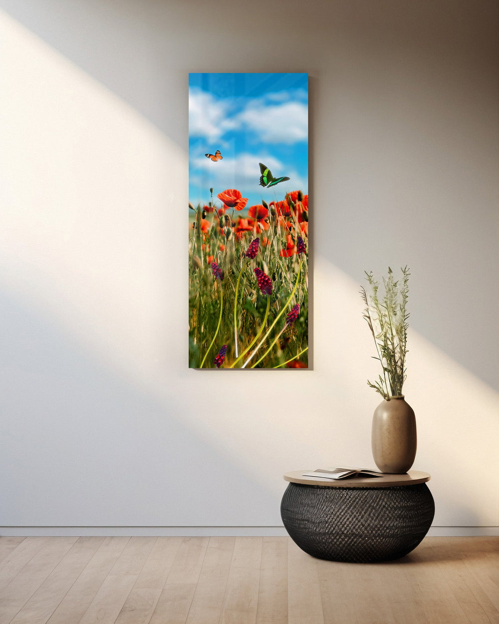 A sunlit meadow of red poppies and purple grape-hyacinth spikes with orange and green butterflies against a bright blue, cloud-dappled sky. panoramic glass wall art A