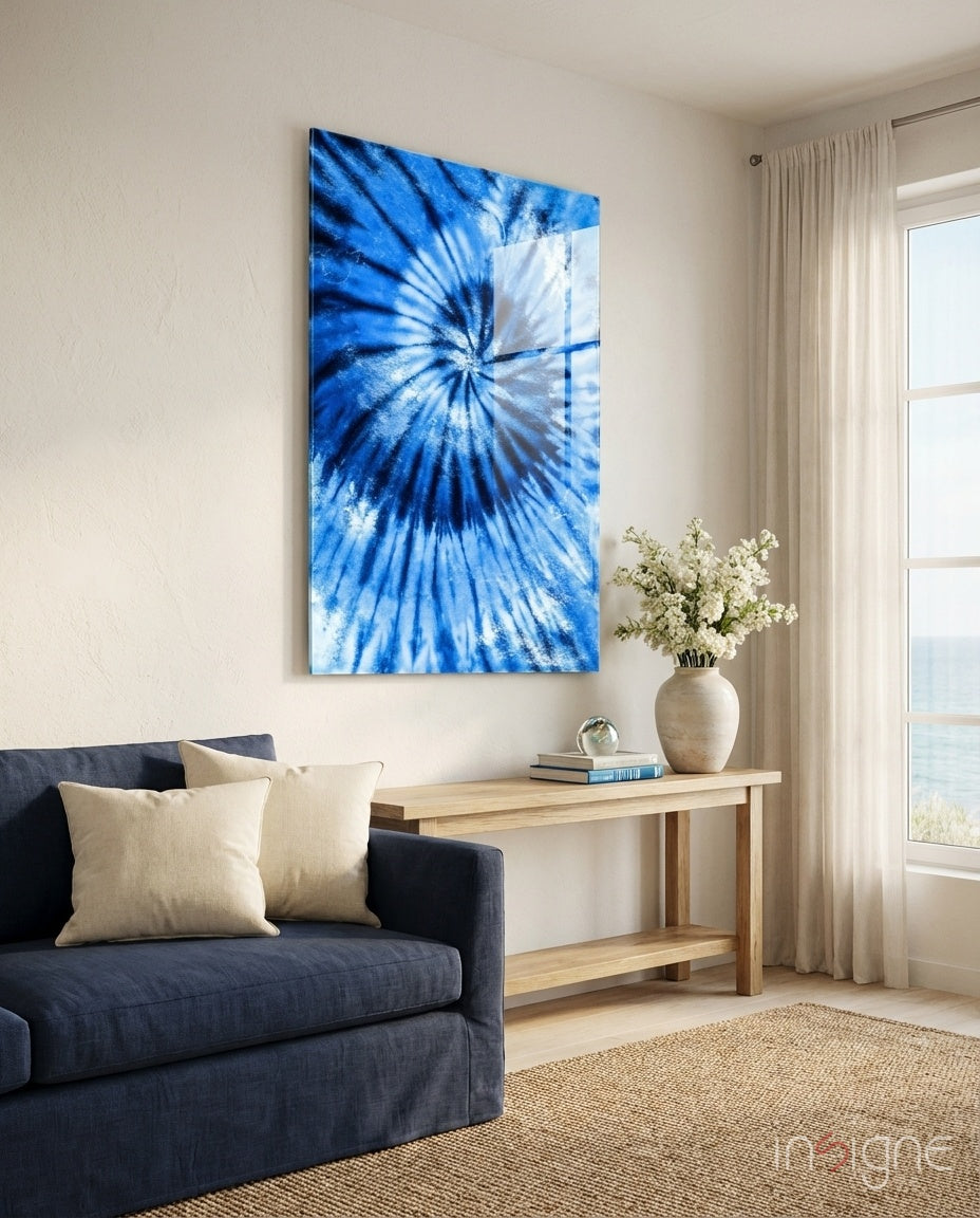 Blue Tie Dye glass wall art displayed above a navy linen sofa in a coastal living room