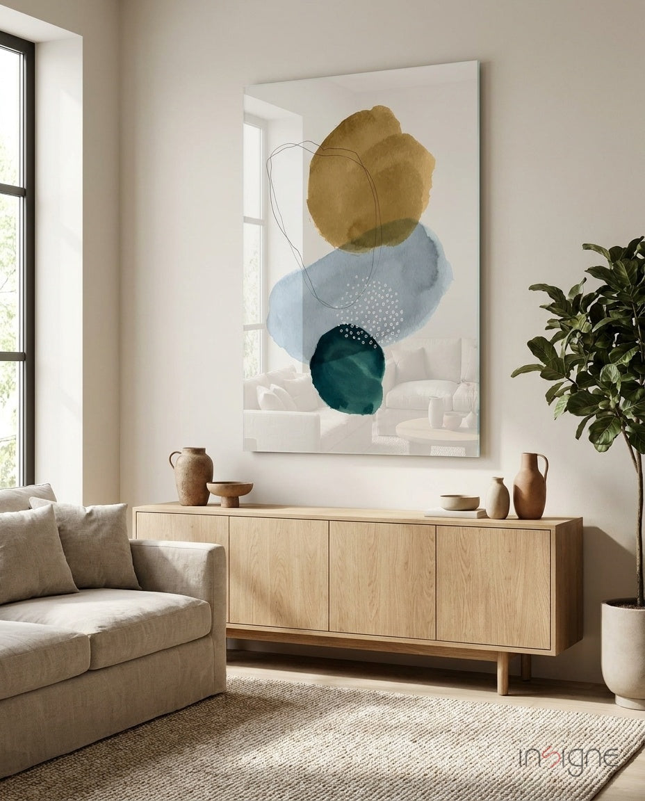 Ochre Stack glass wall art displayed above a wood credenza in a bright minimalist living room