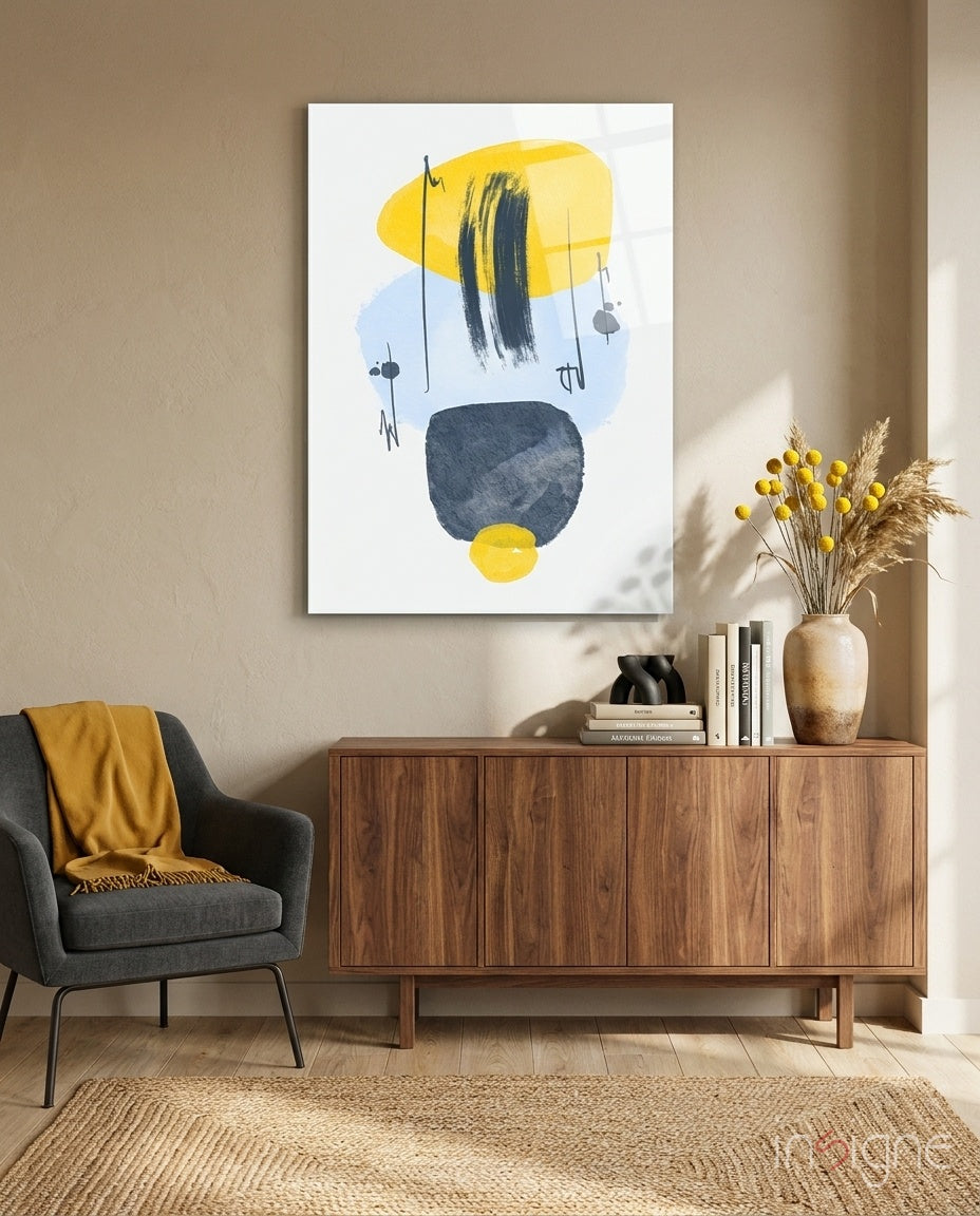 Mustard Wabi glass wall art displayed above a walnut credenza in a warm earth-toned lounge with charcoal armchair