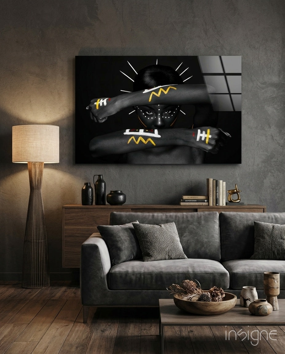 Tribal Spirit glass wall art displayed above a walnut credenza in a warm wood-paneled lounge with grey velvet sofa