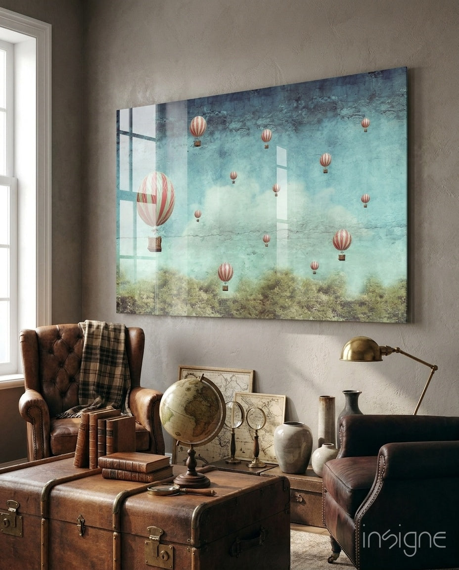 Vintage Balloons glass wall art displayed above a wood console in a vintage study with brown leather wingback chair