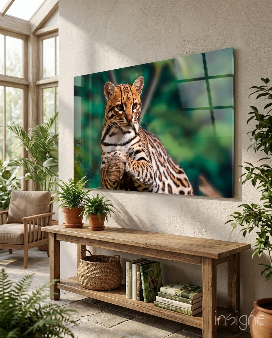 Ocelot Gaze glass wall art displayed above a wood console in a bright biophilic conservatory with rattan chair and ferns