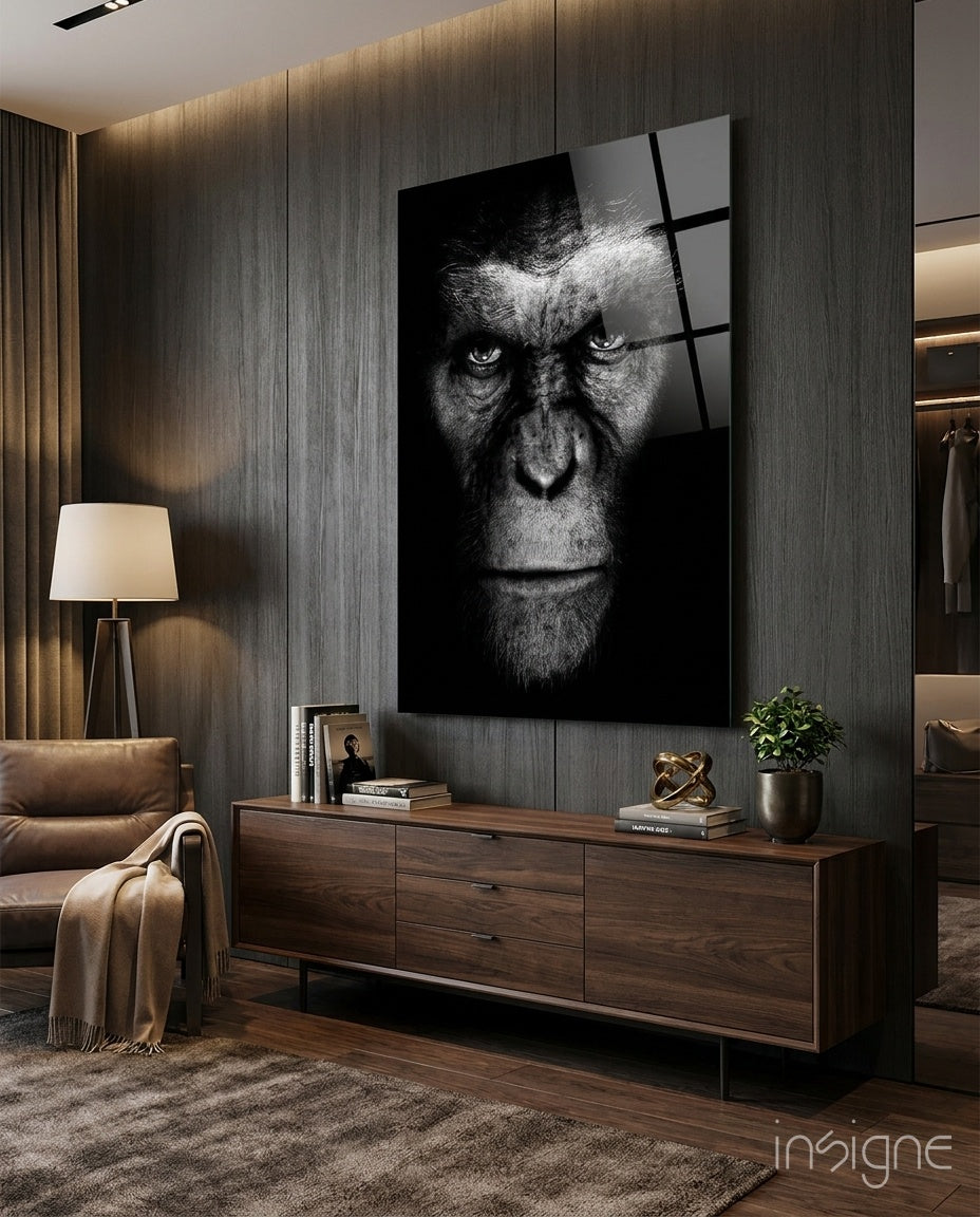 Chimp Gaze glass wall art displayed above a walnut credenza in a dark luxe wood-paneled lounge with cognac chair