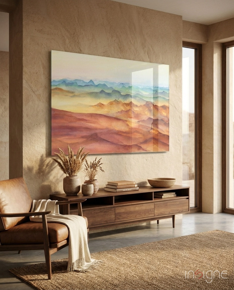 Watercolor Ranges glass wall art displayed above a walnut credenza in a warm sandstone-walled lounge with cognac chair