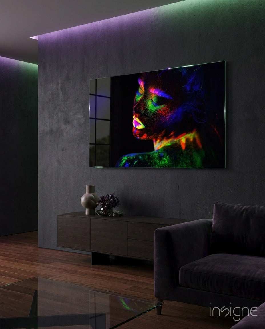 Neon Woman glass wall art displayed above a dark wood credenza in a moody concrete-walled lounge with magenta and green LED accents