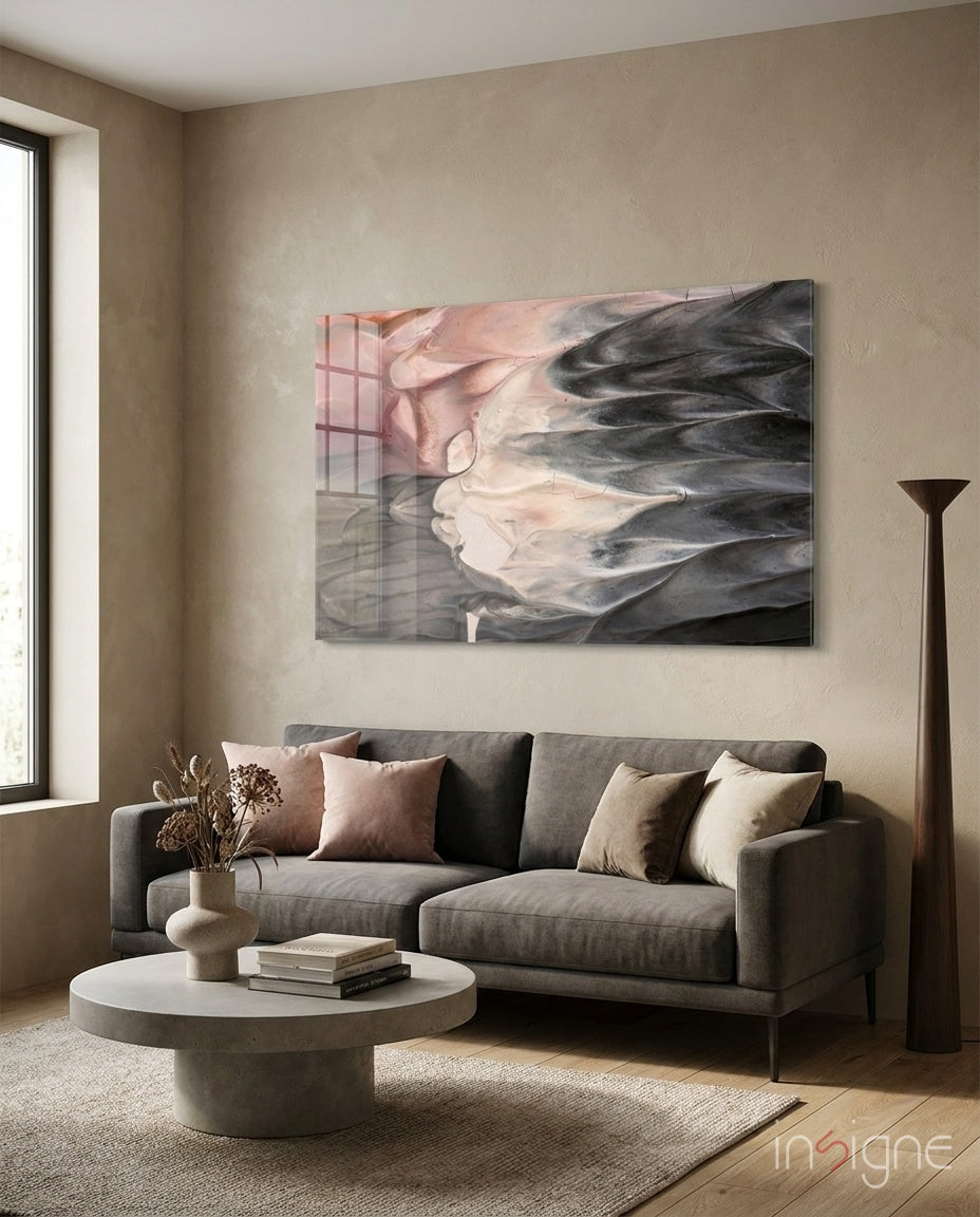 Abstract glass wall art displayed above a charcoal linen sofa in a sand-toned plaster lounge with concrete coffee table and pampas vase