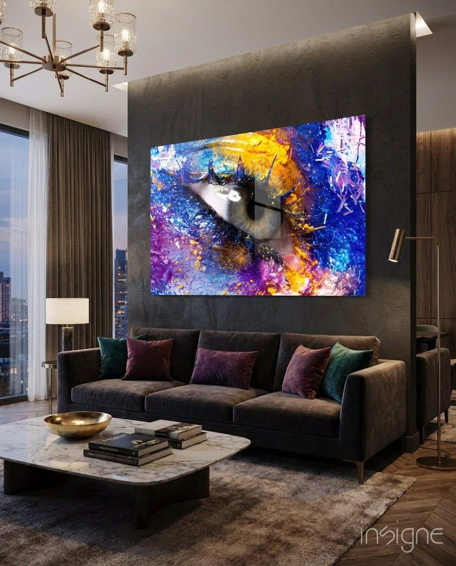 Pupil glass wall art displayed above a charcoal velvet sofa in a moody concrete-walled lounge with marble coffee table and crystal chandelier