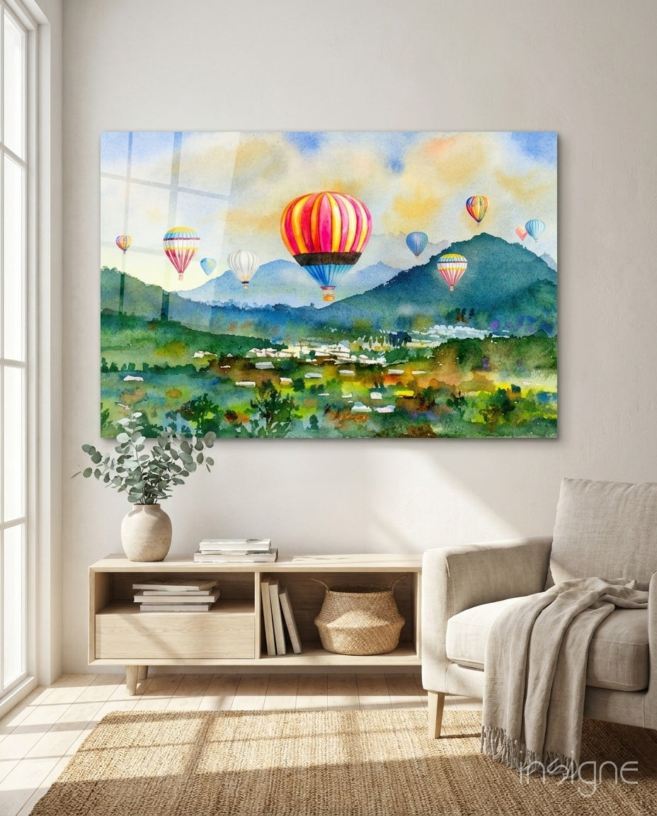 Hot Air Balloons glass wall art displayed above a wood console in a soft white-plaster lounge with cream linen armchair and basket storage
