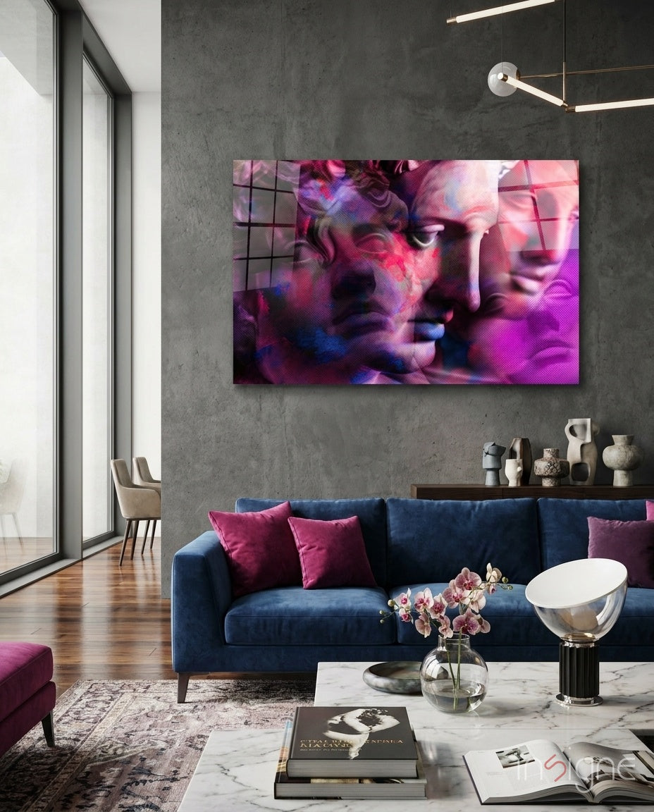 Statues glass wall art displayed above a navy velvet sofa in a moody concrete-walled lounge with magenta velvet pillows and marble coffee table