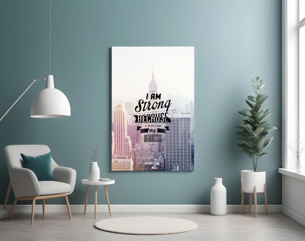 I am Strong glass wall art styled above a desk in an office