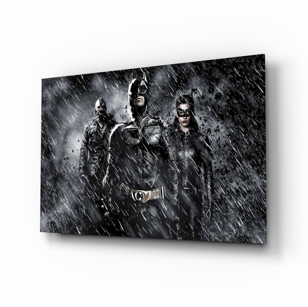 Batman, Catwomen and Bane glass wall art displayed above a black leather sectional in a moody home theater with brass arc lamp and reclaimed-wood console