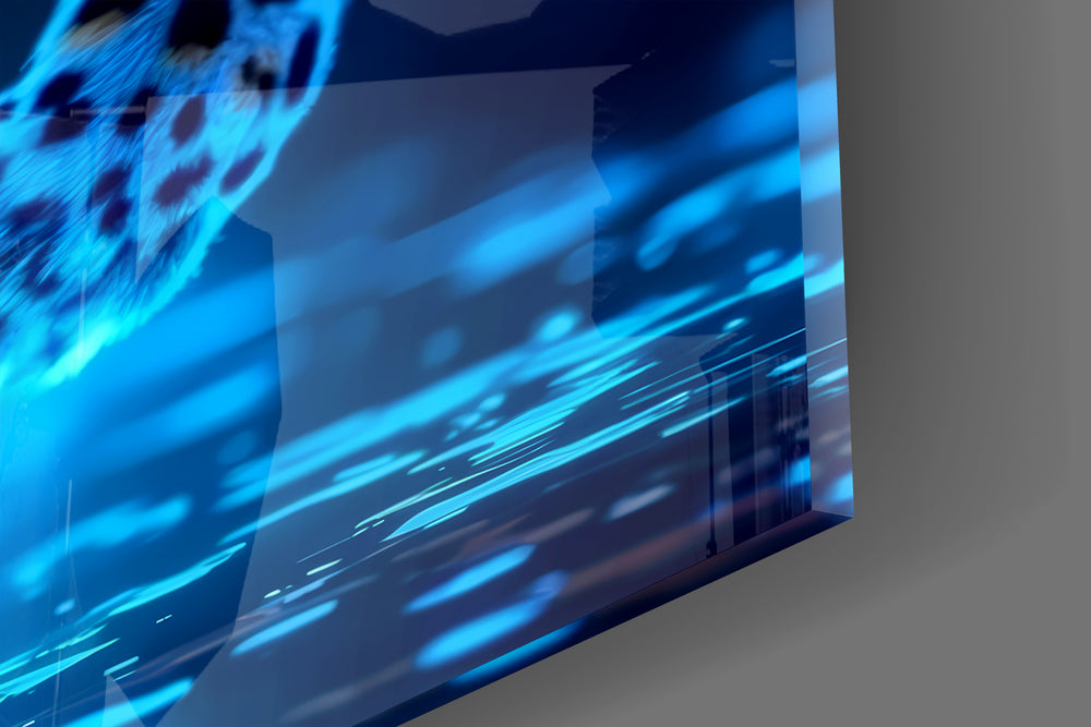 Close-up detail of the cyan-glowing leopard and reflective floor behind glass