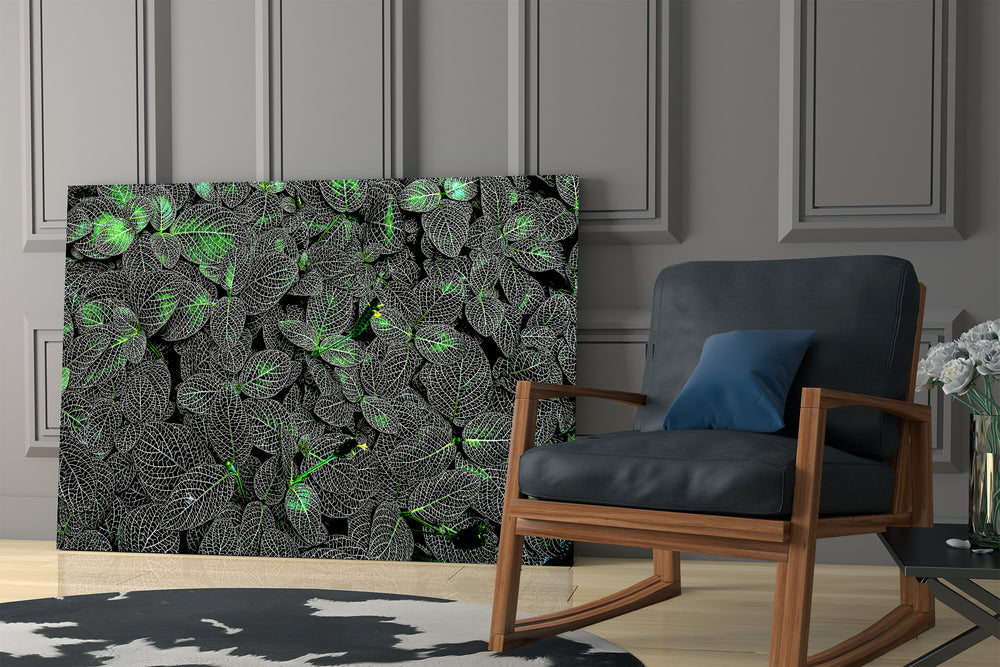 Moody botanical artwork in a creative office with low light