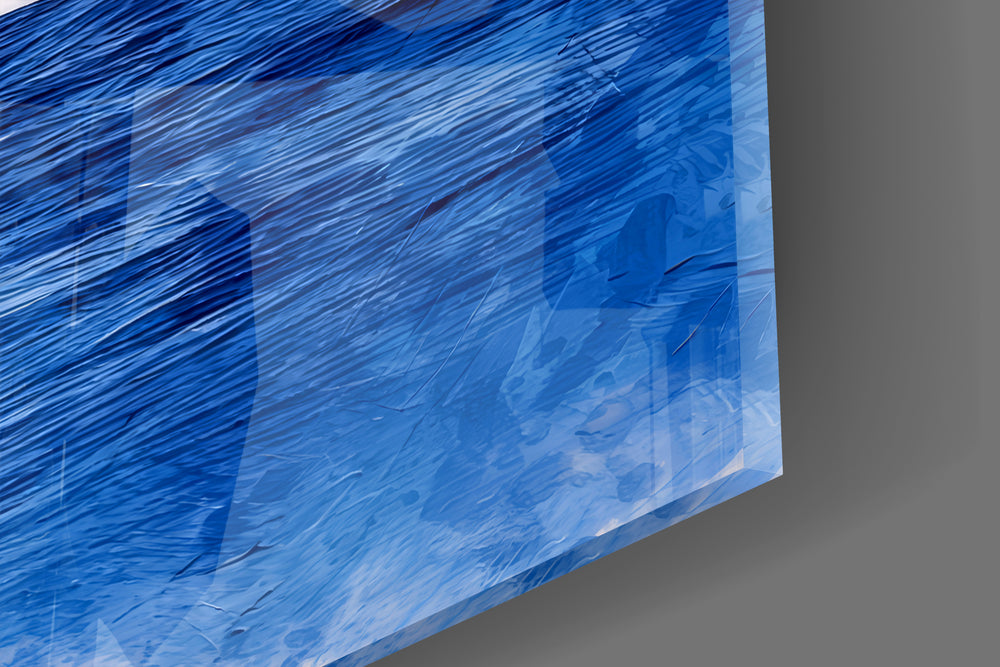 Close-up detail of the whale tail and cobalt ocean behind glass