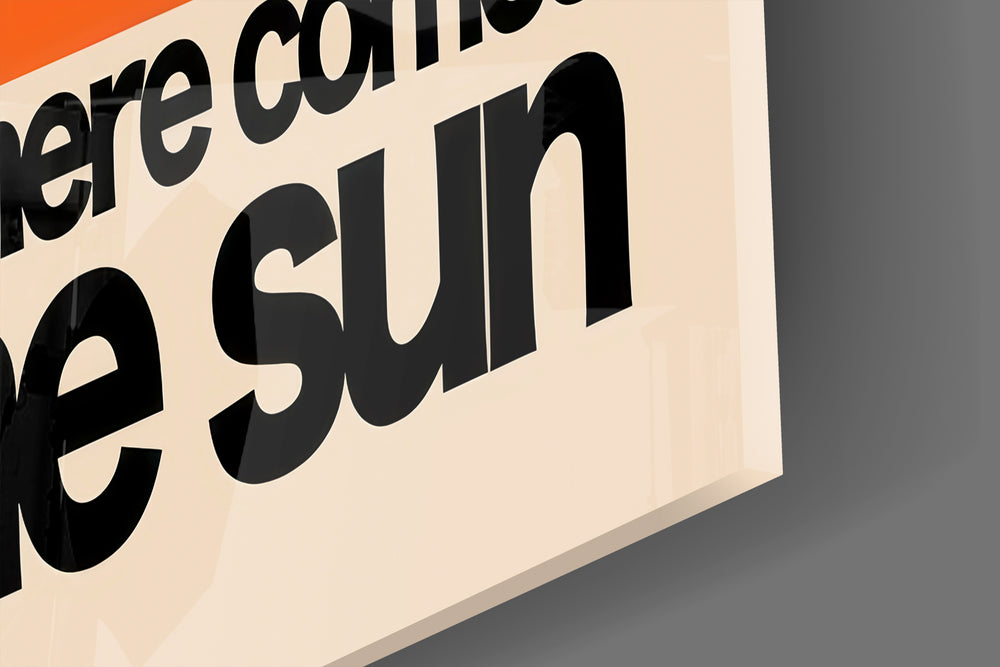 Close-up detail of the tangerine half-disc and black sans-serif behind glass