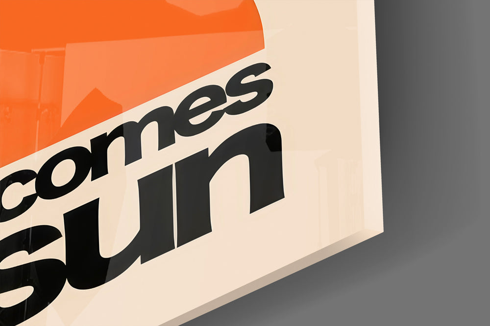 Close-up detail of the tangerine half-disc and black sans-serif behind glass