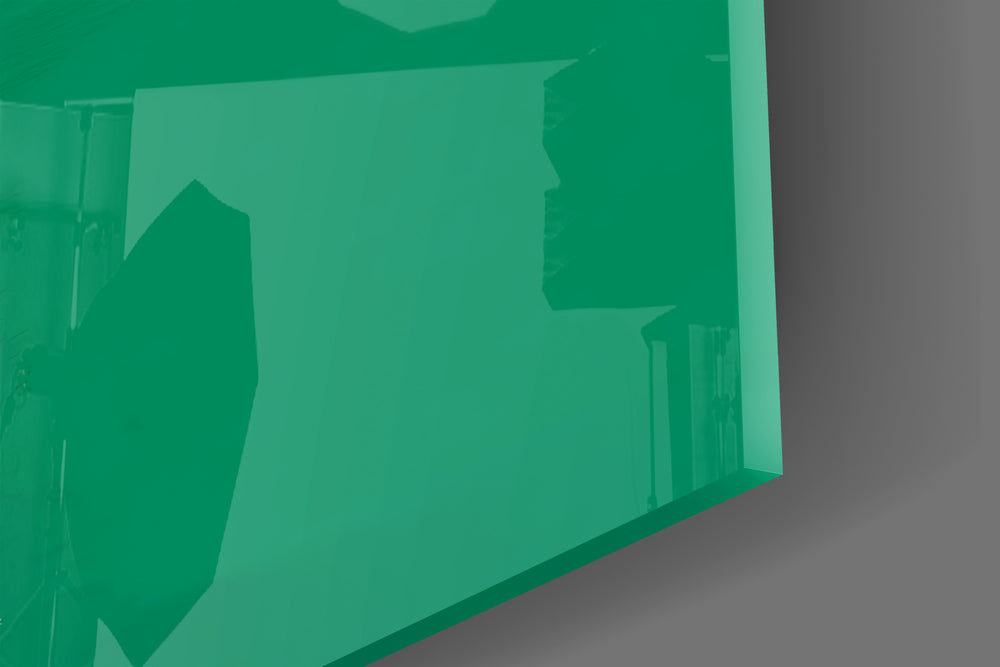 Close-up detail of the alien and white cardboard sign behind glass