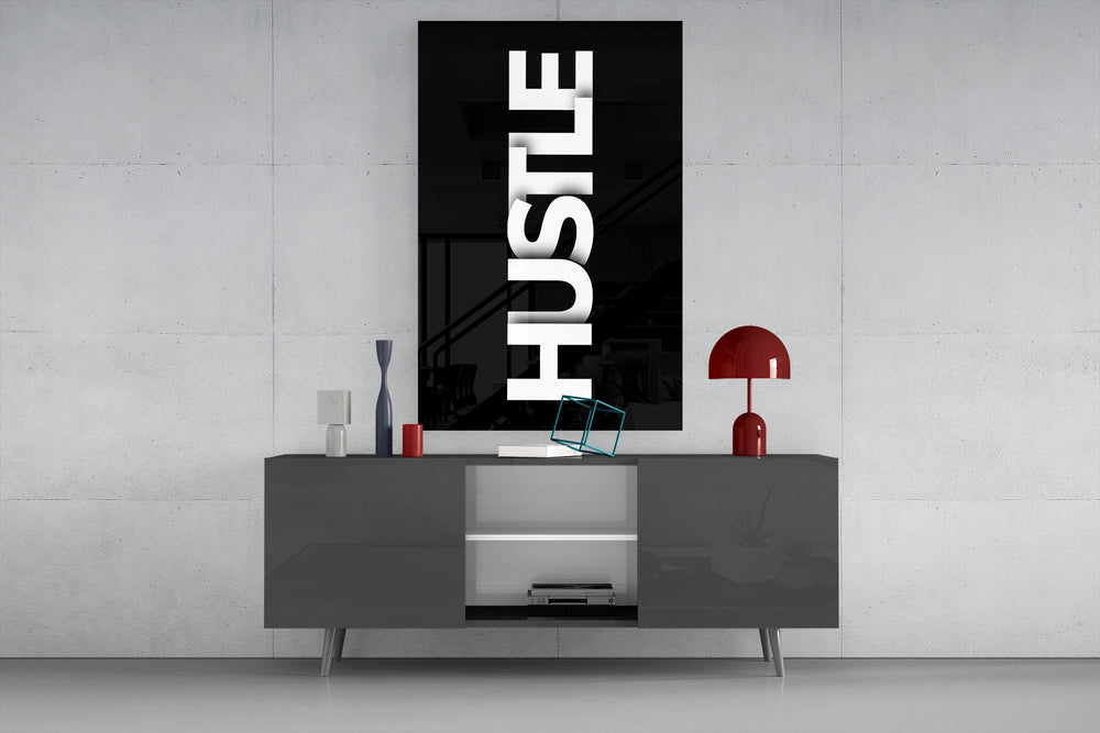 Hustle glass wall art catching light to reveal its high-contrast typography