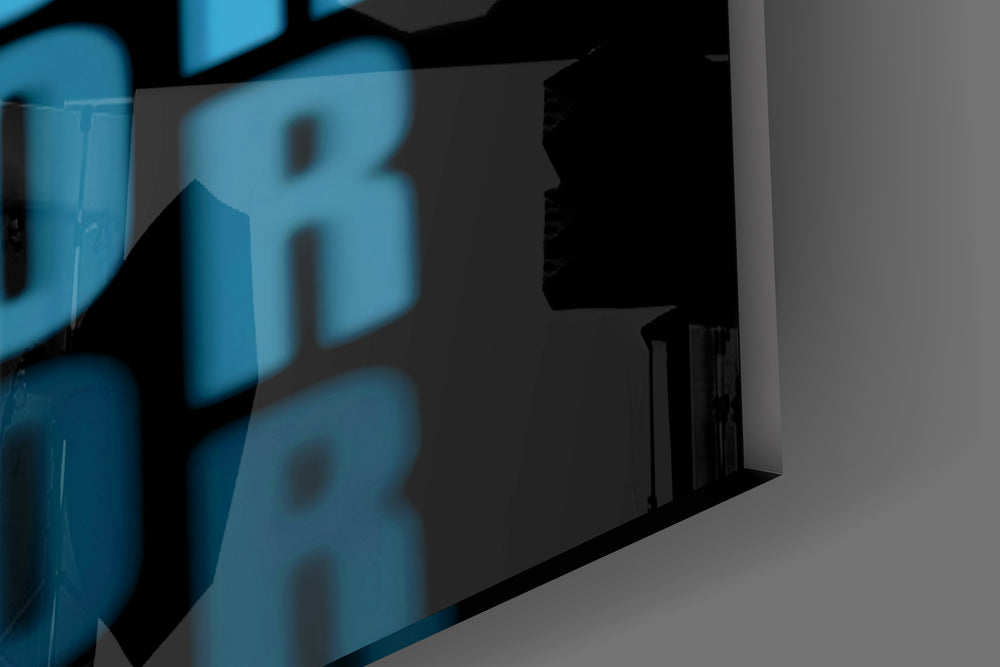 Close-up detail of the cyan repeated typography behind glass