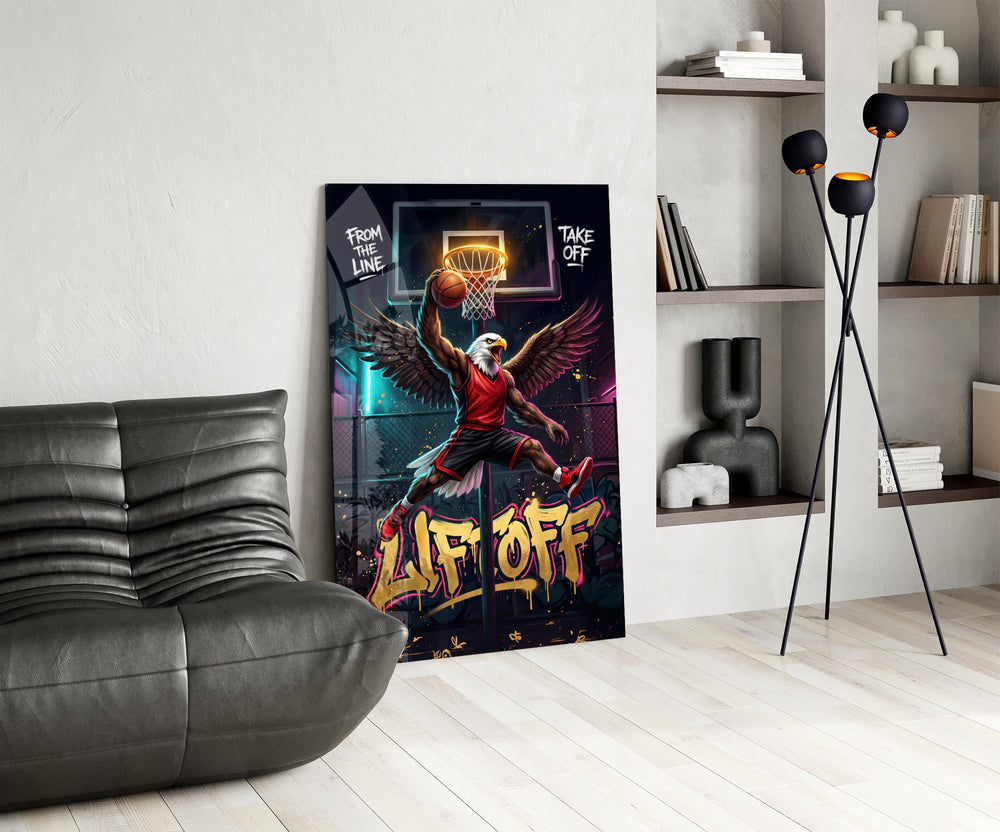 eagle basketball player dunking glass wall art leaning beside a dark leather sofa