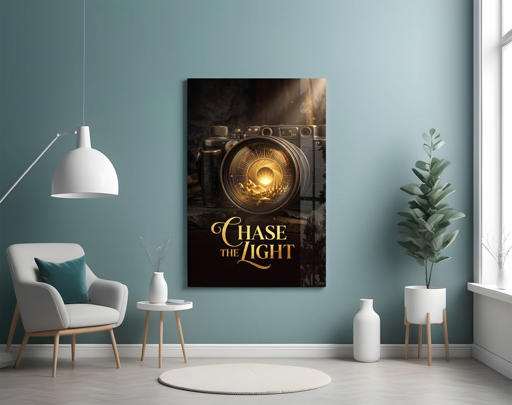 gold vintage camera with a sunrise lens glass wall art styled above an armchair in a reading corner