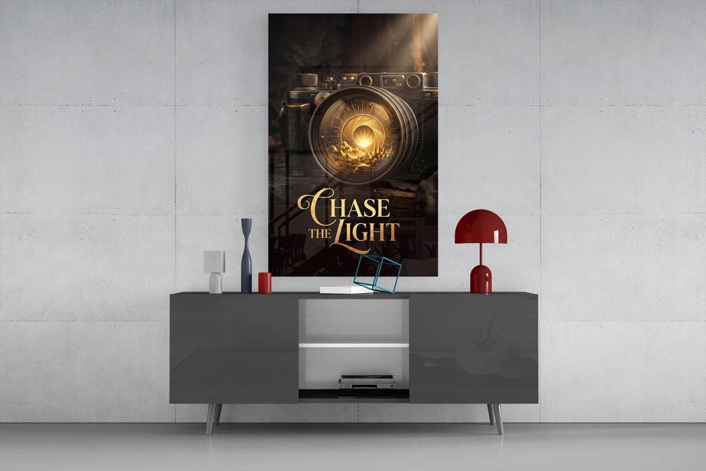 gold vintage camera with a sunrise lens glass wall art displayed above a console in a designer interior