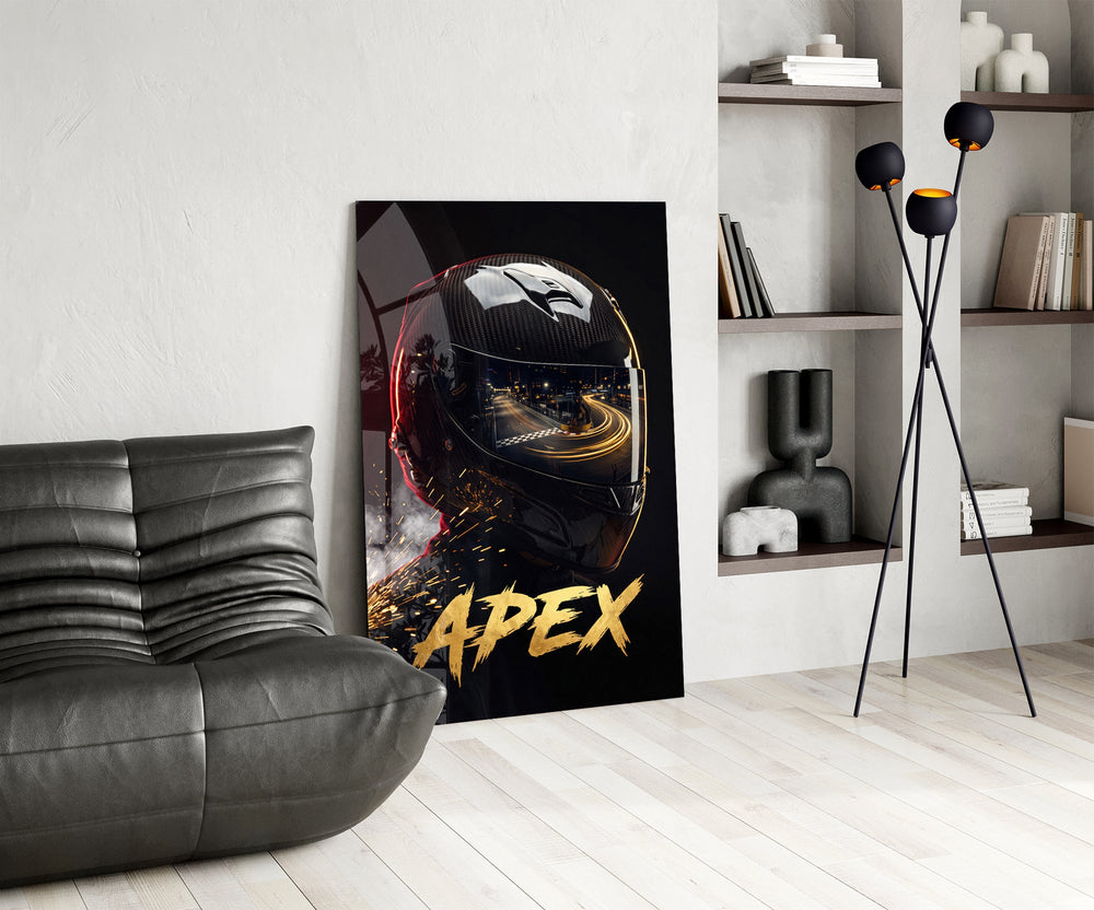 black racing helmet with a track reflection glass wall art leaning beside a dark leather sofa