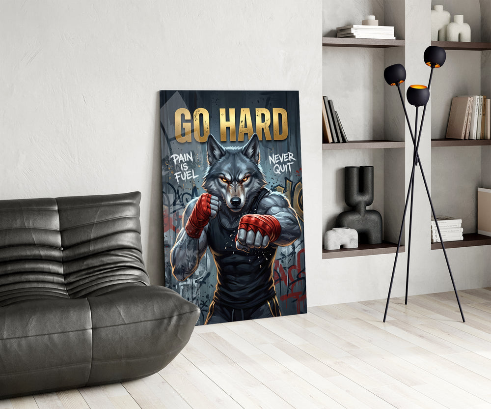 a boxing wolf with red hand wraps glass wall art leaning beside a dark leather sofa