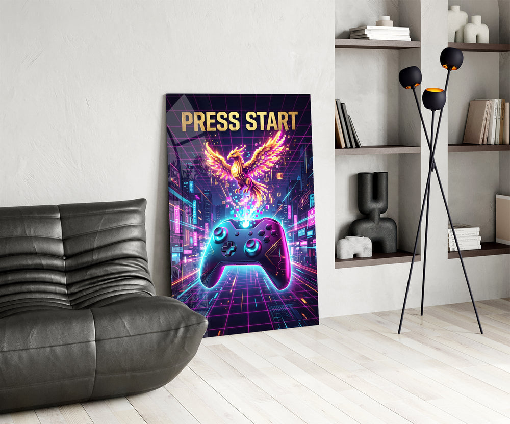 a neon game controller and pixel phoenix glass wall art leaning beside a dark leather sofa