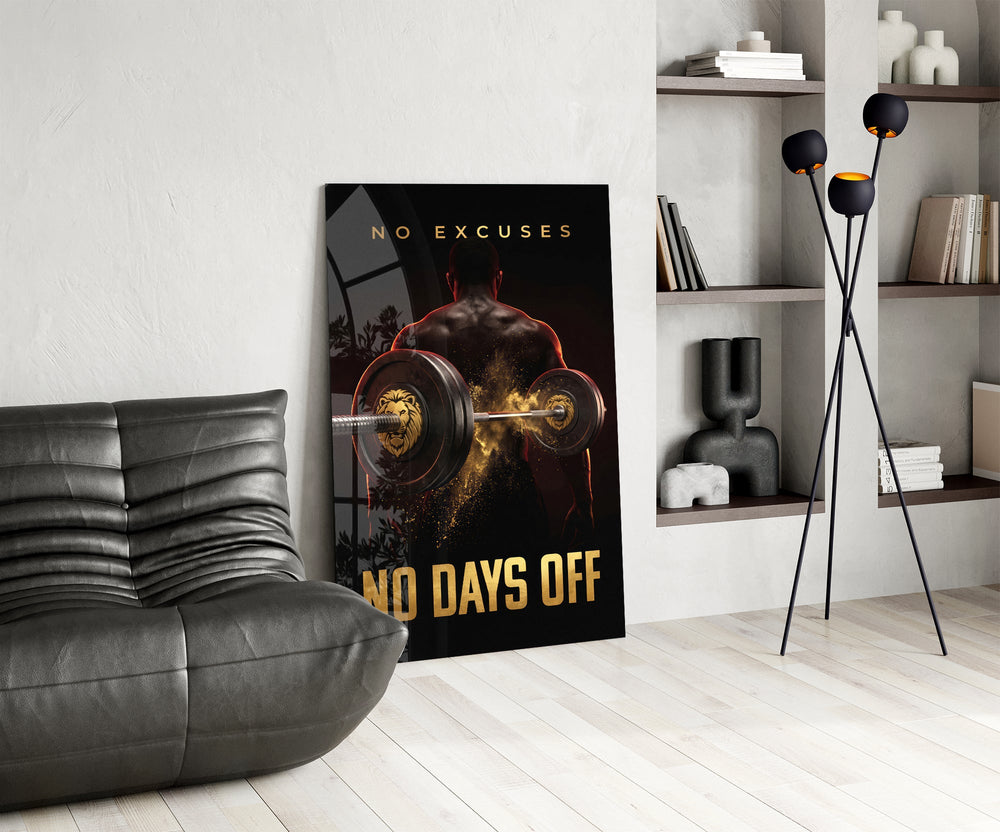 no days off gold barbell motivation glass wall art leaning beside a dark leather sofa