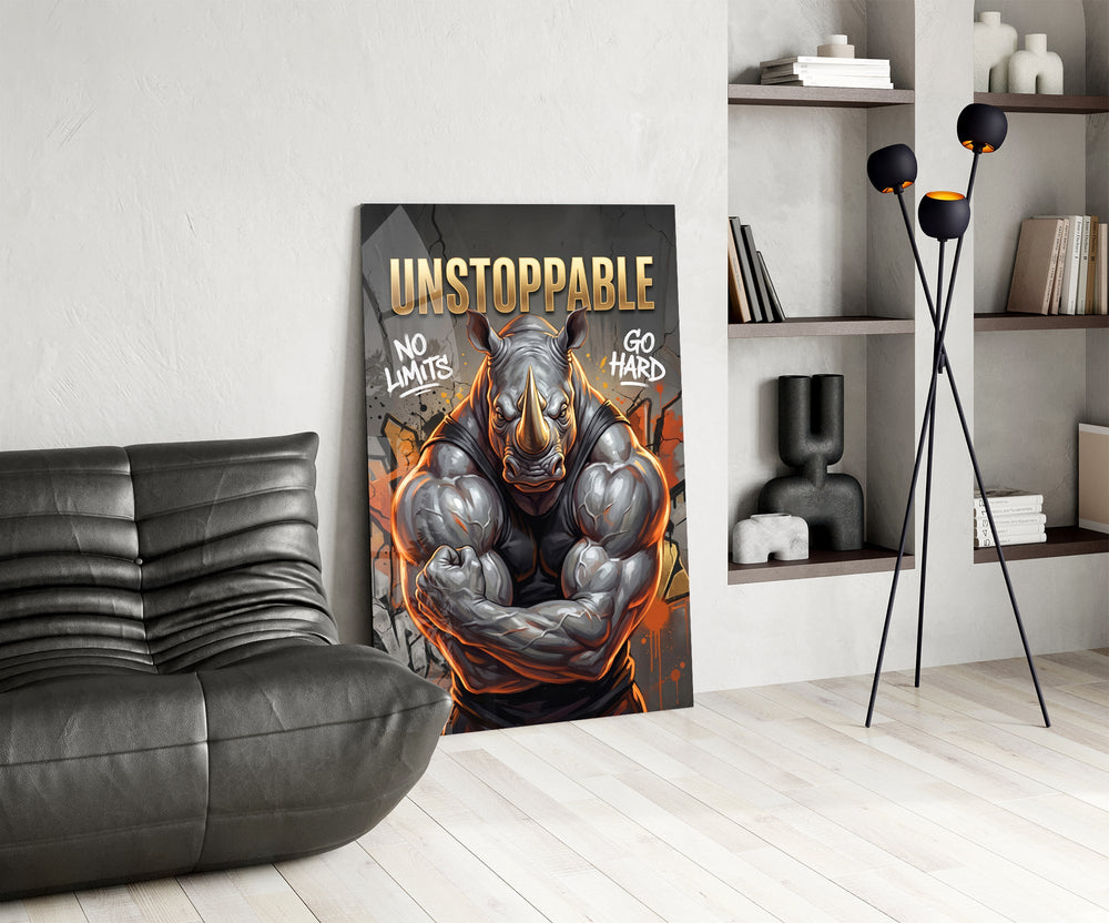 unstoppable muscular rhino bodybuilder glass wall art leaning beside a dark leather sofa
