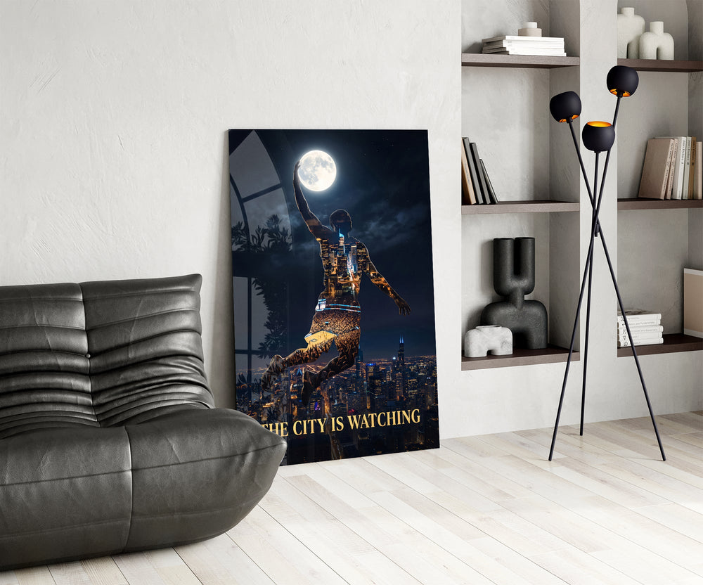 basketball player palming the moon glass wall art leaning beside a dark leather sofa