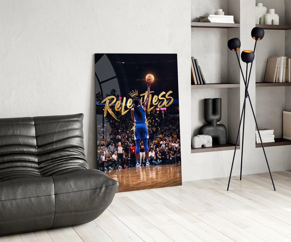 gold Relentless basketball jump shot glass wall art leaning beside a dark leather sofa