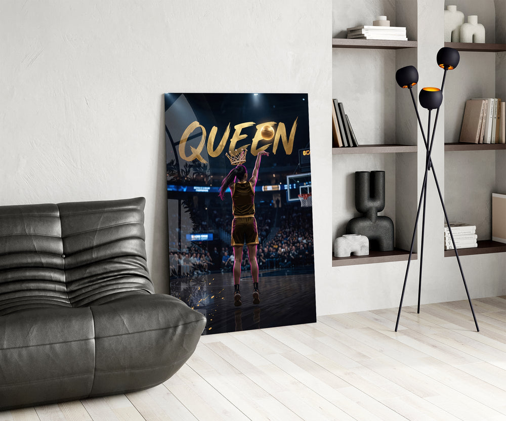 gold Queen basketball shooter glass wall art leaning beside a dark leather sofa