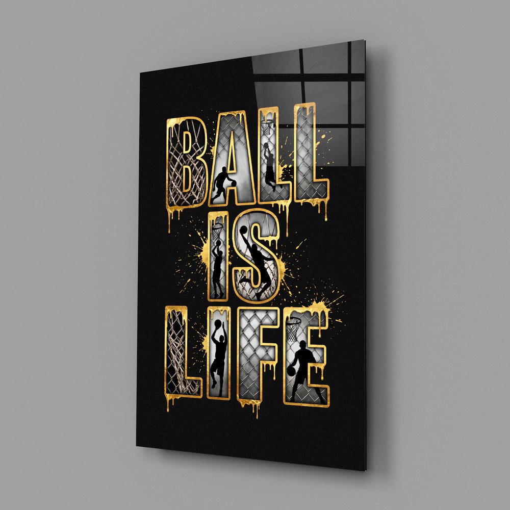 gold Ball Is Life basketball typography glass wall art angled to show the polished tempered glass panel