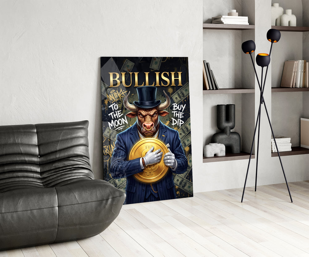 a suited bull holding a gold dollar coin glass wall art leaning beside a dark leather sofa