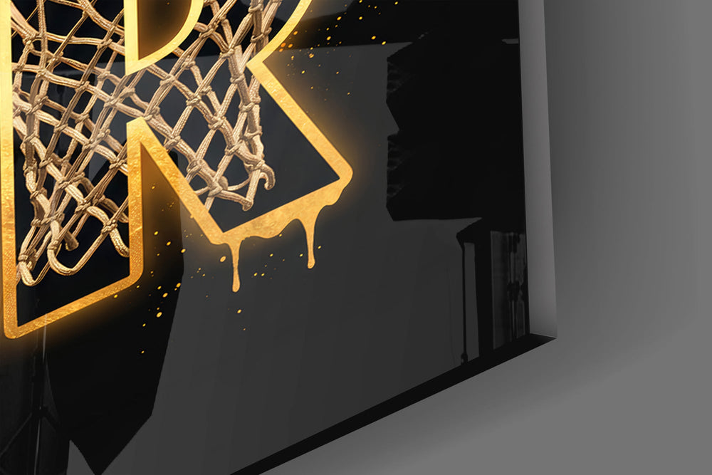 Close-up detail of the mesh-filled gold letters and dribbling silhouette on the glass surface