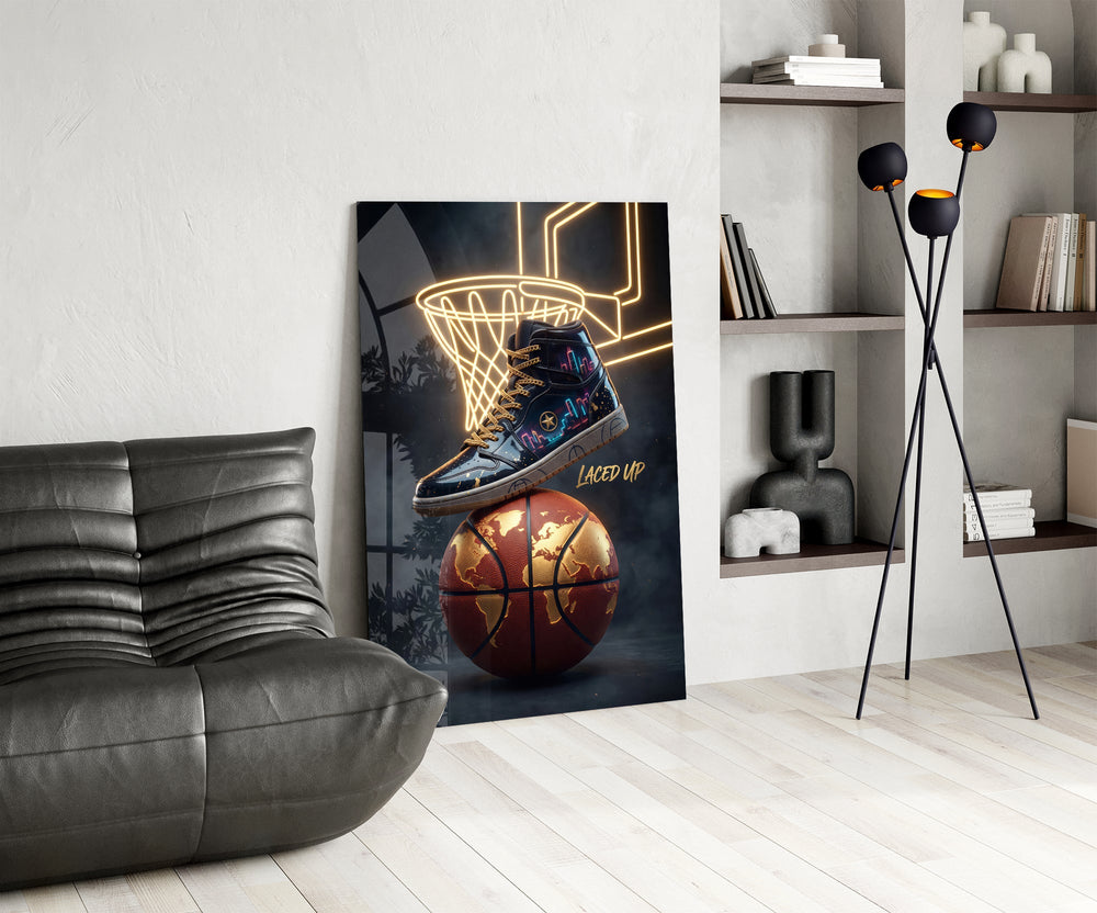a high-top sneaker over a golden globe basketball glass wall art leaning beside a dark leather sofa