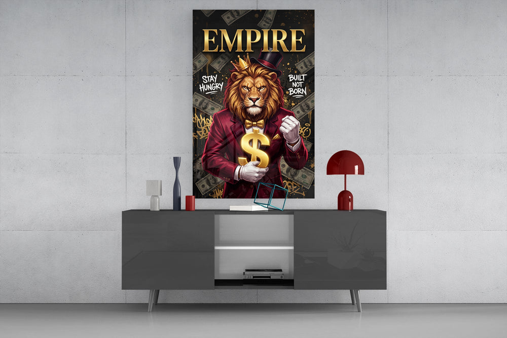 a crowned lion in a red suit holding a gold dollar sign glass wall art displayed above a console in a designer interior