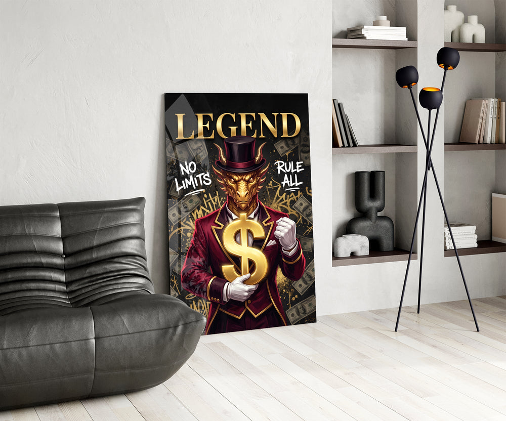 a golden dragon in a suit holding a gold dollar sign glass wall art leaning beside a dark leather sofa