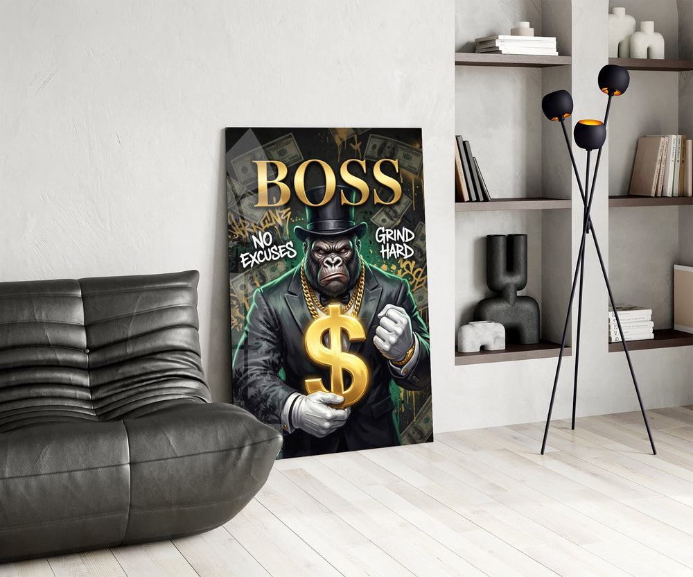 suited gorilla with a gold dollar sign glass wall art leaning beside a dark leather sofa