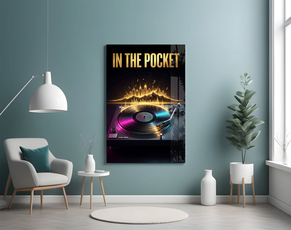 in the pocket golden turntable glass wall art styled above an armchair in a reading corner