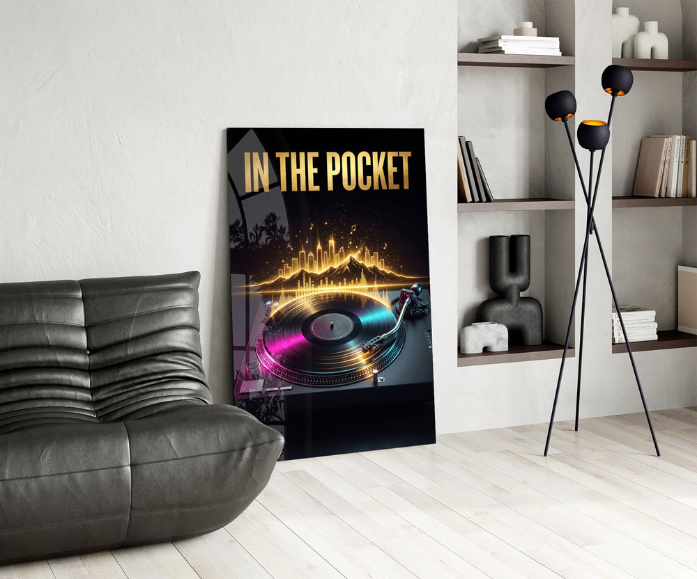 in the pocket golden turntable glass wall art leaning beside a dark leather sofa