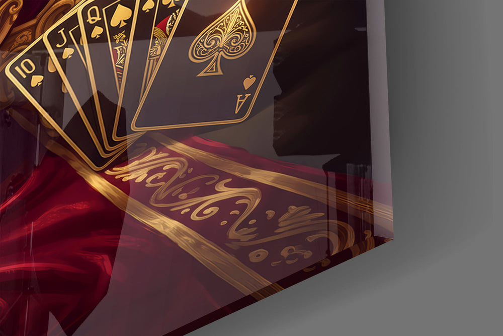 Close-up detail of the ornate gold toilet and the fanned spade royal flush on the glass surface