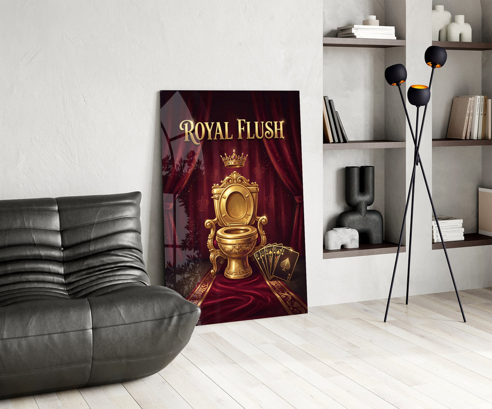 royal flush golden throne toilet glass wall art leaning beside a dark leather sofa